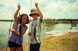 Hudson and Lauren Wilson with two nice bass from Sturdivant Lake (summer, 2002).