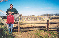 Chad and Hudson Wilson at Club sign